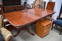 A reproduction banquetting table in the 19th Century style, having gadrooned edge, ball and claw
