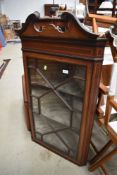 An Edwardian mahogany and inlaid corner display wall cabinet havinbg astral glazed doors and lined