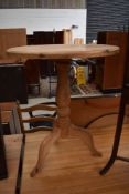 A natural pine pedestal table having circular top, turned pedestal and triple splay legs, diameter