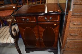 A reproduction Regency style mahogany and inlay enclosed hifi cabinet/cupboard, having serpentine