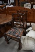 A pair of reproduction ladder back dining chairs