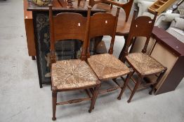 A set of three 19th Century oak dining chairs in the Arts and Crafts style