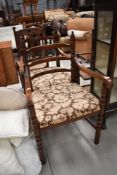 A pair of reproduction oak rail back carver chairs having turned frames