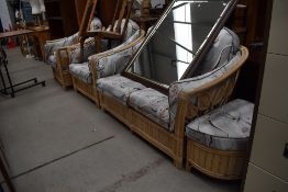 A modern bamboo effect conservatory suite, comp settee , two armchairs and a pouffe, having loose