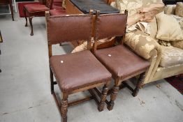A pair of mid 20th Century stained frame dining chairs having rexine studded seats and backs