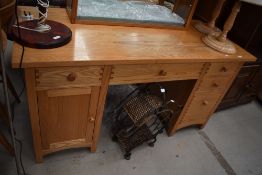 A modern golden oak desk unit, having cupboards and drawers, with joint detail, approx 145 x 64cm