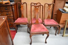 A set of four early 20th Century Queen Anne style mahogany dining chairs having vase backs and