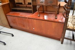A low drop fronted side or similar sideboard having had repair to door