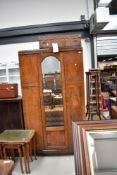 A 1920's walnut and mahogany mirror door wardrobe, approx w 103cm