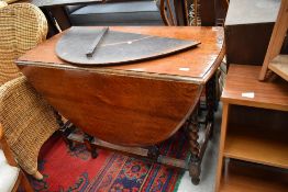An early to mid 20th Century oak twist gate leg dining table, leaf damaged but present