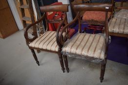 A pair of 19th Century mahogany carver chairs having fluted legs and later upholstery