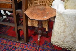 A Victorian mahogany occasional table having turned pedestal base , triple legs and possibly later