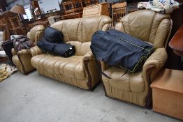 A modern leather three piece suite, in tan with highly polished frame