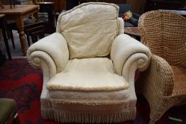 A traditional upholstered armchair in cream