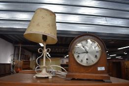An early 20th Century oak cased mantel clock and a painted metal table lamp