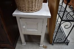 A painted pot cupboard having chunky legs