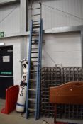 A pair of vintage wooden extending ladders, and a pair of aluminium extending ladders
