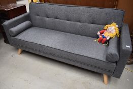 A modern sofa bed, in grey tweed style upholstery, having beech splay legs, width approx. 186cm