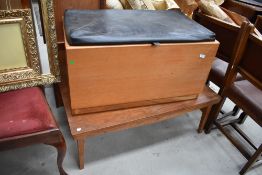 A vintage teak or similar bedding box having vinyl lid (hinged but not currently attached)