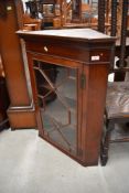 A late Victorian/Edwardian mahogany corner wall display cabinet having astral glazed door