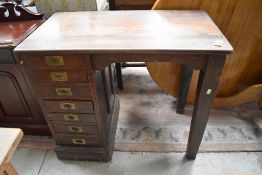 A 19th Century mahogany desk of small proportions having single set of seven drawers , campaign