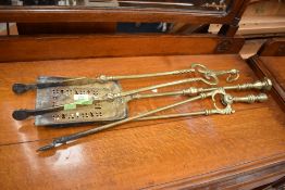 A selection of brass fire irons