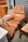 A Stressless armchair and footstool in tan leather