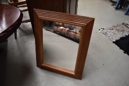 A modern pine frame wall mirror