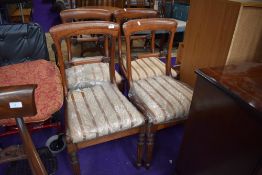 A set of four 19th Century mahogany rail back dining chairs having fluted legs and later upholstery