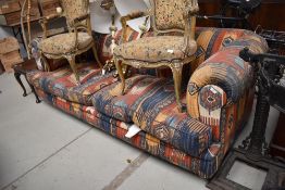 A modern settee, having traditional Eastern tapestry rug upholstery