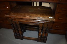 A traditional oak refectory style nest of tables, largest table approx. 56 x 35cm