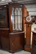 A reproduction Regency corner display cabinet with cupboard under
