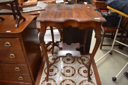 An early 20th Century mahogany occasional table having shaped top and undertier, width approx. 50cm