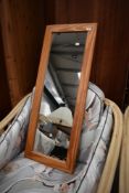 A modern pine frame wall mirror
