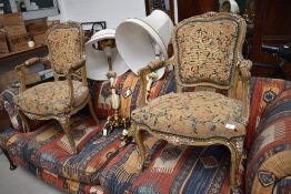 A pair of C19th gilt wood armchairs, in the French style, having tapestry upholstery