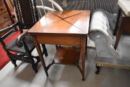 A Victorian mahogany envelope card table, having square tapered legs, red beize interior in need