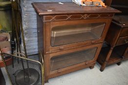 An early 20th Century light mahogany stacking style two tier bookcase, width approx. 94cm, height