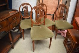 A set of four reproduction dining chairs , nice quality with motif to back, over stuffed seats