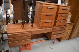 A vintage teak and laminate dressing table and pair of similar bedside drawers, dressing table width