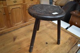 A late 19th Century carved oak stool/milking copy (three legs)