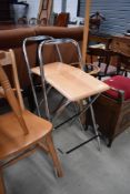 A pair of beech and chrome folding bar stools