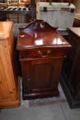 A reproduction mahogany effect pot cupboard