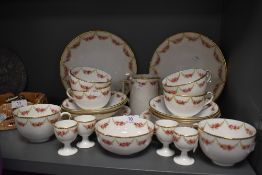 A partial Wearing and Gillow tea service comprising of egg cups,cups and saucers,jug and plates