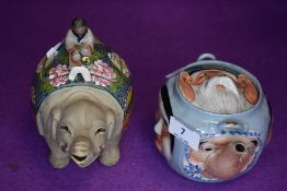 A vintage Chinese novelty tea pot having different masks/faces to each side,wicker handle not