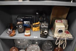 An assortment of cameras,binoculars,Cine Kodak and an Aldis projector.