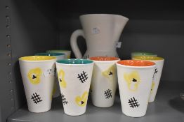 A mid century Vallauris lemonade set designed by Andre Baud, having cream ground with abstract