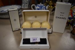 A selection of Channel No.5 beauty products including soap, talc and small spray perfume in