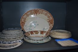 An assortment of vintage ceramics including Meakin plates, platters and bowls.