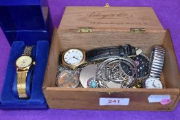 A vintage wooden cigar box containing a selection of necklaces and wrist watches including a cased