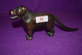 A vintage nutcracker in the form of a dog stamped made in England with reg mark